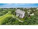 Picturesque view of the home featuring lush greenery and a beautifully landscaped backyard at 6303 Ellingwood Point Pl, Castle Rock, CO 80108