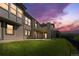 Exterior view of the home featuring a walkout basement, large yard, and deck at 6303 Ellingwood Point Pl, Castle Rock, CO 80108