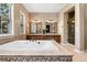 Luxurious bathroom featuring a soaking tub, double vanities, and a glass-enclosed shower at 6303 Ellingwood Point Pl, Castle Rock, CO 80108