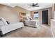Bright bedroom featuring two beds, large window and neutral decor at 6303 Ellingwood Point Pl, Castle Rock, CO 80108