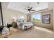 Spacious bedroom featuring a ceiling fan, large window, and neutral decor at 6303 Ellingwood Point Pl, Castle Rock, CO 80108