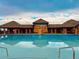 Community pool with a clubhouse in the background, offering a relaxing and social atmosphere at 6303 Ellingwood Point Pl, Castle Rock, CO 80108