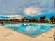 Large community pool with lounge chairs, a shelter, and a slide for Gathering enjoyment at 6303 Ellingwood Point Pl, Castle Rock, CO 80108