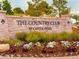 Beautiful community sign for The Country Club at Castle Pines with colorful landscaping at 6303 Ellingwood Point Pl, Castle Rock, CO 80108