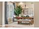 Bright dining area featuring hardwood floors, stylish lighting, and large windows with backyard views at 6303 Ellingwood Point Pl, Castle Rock, CO 80108