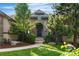 Charming stone home featuring a well-manicured lawn, beautiful landscaping, and a welcoming front entrance at 6303 Ellingwood Point Pl, Castle Rock, CO 80108