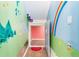 Playful hallway with colorful mural art and a unique -size doorway at 6303 Ellingwood Point Pl, Castle Rock, CO 80108