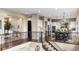 This kitchen features white cabinets, stainless steel appliances, and a breakfast bar at 6303 Ellingwood Point Pl, Castle Rock, CO 80108