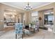 Spacious open-concept living room featuring stylish furniture and a view of the dining room at 6303 Ellingwood Point Pl, Castle Rock, CO 80108
