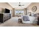 Spacious main bedroom with a sitting area, ceiling fan, and scenic views from the windows at 6303 Ellingwood Point Pl, Castle Rock, CO 80108