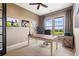 Comfortable home office with a large desk, comfortable chair, and windows with scenic views at 6303 Ellingwood Point Pl, Castle Rock, CO 80108