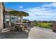 Outdoor deck featuring outdoor dining area, an umbrella, and scenic views at 6303 Ellingwood Point Pl, Castle Rock, CO 80108