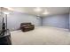 Spacious basement Gathering room with gray carpet and a leather couch at 6995 S Ash Cir, Centennial, CO 80122