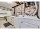 Clean laundry room in the basement, featuring washer, dryer, and storage at 6995 S Ash Cir, Centennial, CO 80122