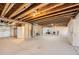 Large unfinished basement with open layout and exposed ceiling beams, perfect for future expansion at 14521 Vancouver Pl, Parker, CO 80134