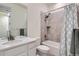 Well-lit bathroom featuring a shower-tub combo, neutral tile, and ample counter space at 14521 Vancouver Pl, Parker, CO 80134