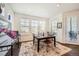 Bright dining area with decorative rug, lots of windows, a modern chandelier and an outside view at 14521 Vancouver Pl, Parker, CO 80134