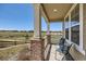 Relaxing front porch with views of open space, ideal for outdoor seating at 14521 Vancouver Pl, Parker, CO 80134
