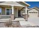 Cozy front porch with brick pillars, perfect for enjoying quiet moments outdoors at 14521 Vancouver Pl, Parker, CO 80134