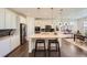 Bright kitchen with a center island, barstool seating, stainless appliances, and modern backsplash at 14521 Vancouver Pl, Parker, CO 80134