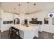 Stylish kitchen with white cabinets, stainless steel appliances, and a large center island, open concept at 14521 Vancouver Pl, Parker, CO 80134