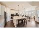 Open-concept kitchen with stainless steel appliances, large island, and attached dining space at 14521 Vancouver Pl, Parker, CO 80134