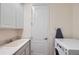 Functional laundry room with modern washer and dryer, sink, and ample storage cabinets at 14521 Vancouver Pl, Parker, CO 80134