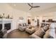 Spacious living room flows into kitchen, featuring fireplace and hardwood floors, perfect space at 14521 Vancouver Pl, Parker, CO 80134
