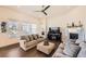 Bright living room with a fireplace, dark floors, and stylish, modern furnishings at 14521 Vancouver Pl, Parker, CO 80134