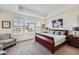 Spacious main bedroom with trey ceilings, a sitting chair, and lots of natural light at 14521 Vancouver Pl, Parker, CO 80134
