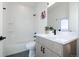 Modern bathroom with white subway tile, black fixtures, and a sleek vanity with wood grain cabinets at 2920 W Parkside Pl, Denver, CO 80221