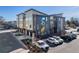 Exterior view of modern townhomes featuring multi-tone exteriors, attached garages, and a mural on the side at 2920 W Parkside Pl, Denver, CO 80221