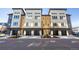 Modern townhome exterior showcasing a contemporary design with a black garage door and multi-tone color scheme at 2920 W Parkside Pl, Denver, CO 80221