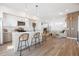 Open floor plan with modern kitchen, island with bar stool seating, and living room, creating an inviting space at 2920 W Parkside Pl, Denver, CO 80221