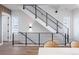 Modern staircase with sleek black metal railing, bright white walls, and contemporary lighting at 2920 W Parkside Pl, Denver, CO 80221