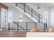 Modern staircase with sleek black railings and natural light from windows, creating a stylish and open design at 2920 W Parkside Pl, Denver, CO 80221