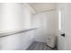 Clean, white walk-in closet with ample shelving and hanging space, providing practical storage solutions at 2920 W Parkside Pl, Denver, CO 80221