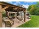 Spacious backyard patio with comfortable seating area, hanging chair, BBQ and outdoor kitchen at 6621 E Peakview Pl, Centennial, CO 80111