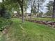 Lush backyard with mature trees and a rock wall, offering a serene outdoor space at 6621 E Peakview Pl, Centennial, CO 80111
