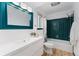 Beautiful bathroom featuring vanity with a bold mirror, toilet, and shower-tub combination at 6621 E Peakview Pl, Centennial, CO 80111