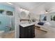 Bright primary bath featuring a white vanity with a black cabinet, soaking tub and shower at 6621 E Peakview Pl, Centennial, CO 80111