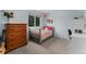 Cozy bedroom featuring a comfortable bed, wood dresser, decor and a window that provides natural light at 6621 E Peakview Pl, Centennial, CO 80111