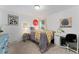 Well-lit bedroom decorated with colorful accents, a comfortable bed, and white decor and desk space at 6621 E Peakview Pl, Centennial, CO 80111