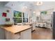 Bright kitchen featuring a large window, island with seating and butcher block countertops at 6621 E Peakview Pl, Centennial, CO 80111