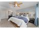 Comfortable main bedroom with a large bed, ceiling fan and an ensuite bathroom with double sinks at 6621 E Peakview Pl, Centennial, CO 80111
