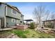Backyard view of the property with a hot tub, pergola, pond, stone landscaping, and small grass area at 11207 Day Star Ct, Parker, CO 80138