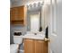 Bathroom with oak vanity and a large mirror with vanity lighting at 11207 Day Star Ct, Parker, CO 80138