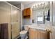 Bathroom with a walk-in shower, vanity, and cabinet storage at 11207 Day Star Ct, Parker, CO 80138