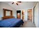 Bedroom featuring neutral walls, carpeted floor, and a large wooden dresser with a mirror at 11207 Day Star Ct, Parker, CO 80138