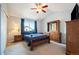 Comfortable bedroom with large window, ceiling fan, and a wooden dresser at 11207 Day Star Ct, Parker, CO 80138